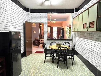 a dining room with a table and chairs in a kitchen at Canning Garden-The Ipohscape in Ipoh