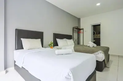 two beds with white sheets in a room at Family Retreat Cozy Stay in Brinchang Cameron Highlands Clover Home M-08 in Brinchang