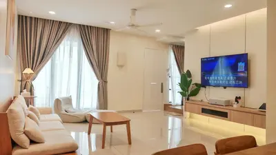 a living room with a couch and a tv at No 8 Homestay in Pangkor