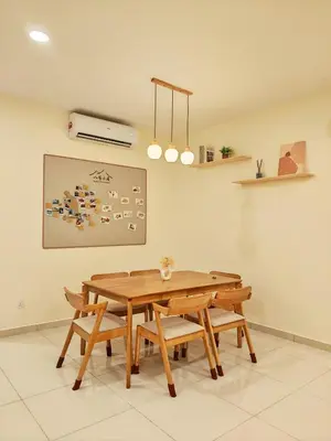a dining room with a wooden table and chairs at No 8 Homestay in Pangkor