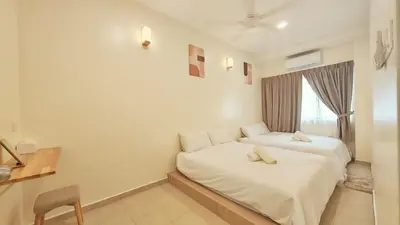 a bedroom with two beds and a window at No 8 Homestay in Pangkor
