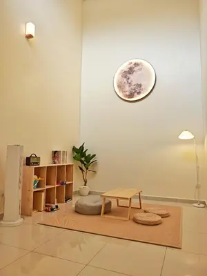 a room with a table and a clock on the wall at No 8 Homestay in Pangkor