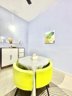 a dining room with a table and yellow chairs at H&Z Guesthouse Kulim Hi-Tech - Free Wifi - Netflix in Kulim
