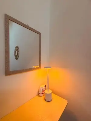 a table with a lamp and a mirror on it at H&Z Guesthouse Kulim Hi-Tech - Free Wifi - Netflix in Kulim