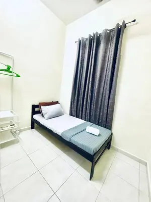 a small bed in a room with a black curtain at H&Z Guesthouse Kulim Hi-Tech - Free Wifi - Netflix in Kulim