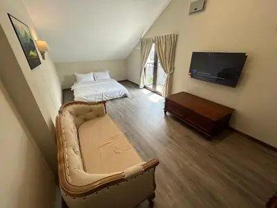 a living room with a couch and a flat screen tv at The Ranch in Ipoh