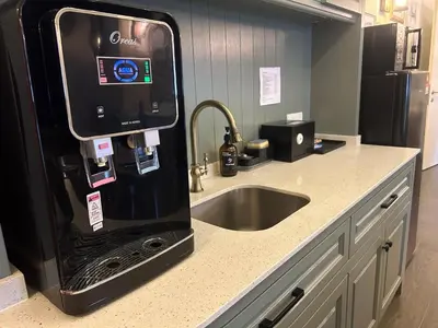 a kitchen with a sink and a black refrigerator at The Ranch in Ipoh