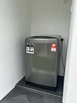 a small refrigerator in a corner of a room at The Ranch in Ipoh