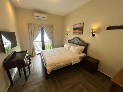 a bedroom with a bed and a piano at The Ranch in Ipoh