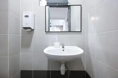 a white sink in a bathroom with a mirror at Clover Nest Cozy & Stylish Studio Retreat Brinchang - Clover Home 2-03 in Brinchang