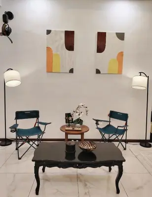 a living room with two chairs and a table at D Banyan Homestay, Sungai Petani, EV Friendly Stay, FREE 22kW in Sungai Petani