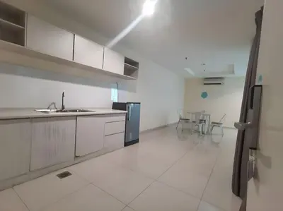 a white kitchen with a sink and a refrigerator at Okay Marina Lumut Homestay in Lumut