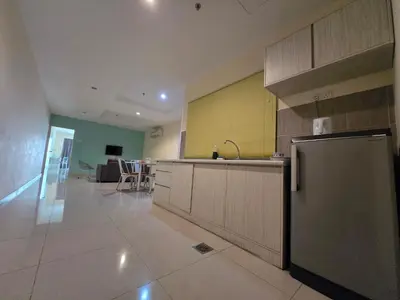 a kitchen with a stainless steel refrigerator in a room at Okay Marina Lumut Homestay in Lumut