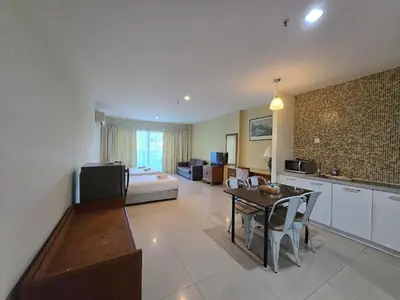 a living room with a kitchen and a dining room at Okay Marina Lumut Homestay in Lumut