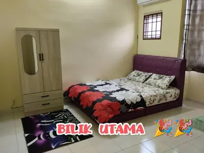 a bedroom with a bed and a dresser in it at Zunnurain Homestay in Kampong Batu Lapan
