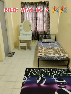 a room with two beds and a table and a chair at Zunnurain Homestay in Kampong Batu Lapan