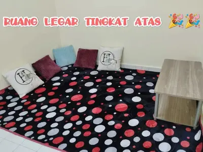 a bedroom with a bed with a black and red carpet at Zunnurain Homestay in Kampong Batu Lapan