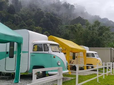 a group of vehicles parked next to each other at The Starry Campervans Cameron Highlands in Cameron Highlands