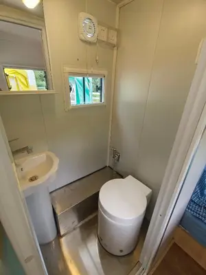 a small bathroom with a toilet and a sink at The Starry Campervans Cameron Highlands in Cameron Highlands