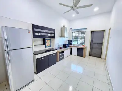 a kitchen with a refrigerator and a ceiling fan at Home in Ipoh in Ipoh