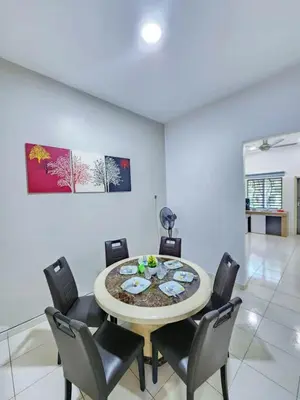 a dining room with a table and chairs at Home in Ipoh in Ipoh