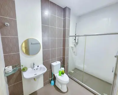 a bathroom with a shower and a toilet and a sink at Home in Ipoh in Ipoh