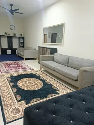 a living room with a couch and a rug at Amirah homestay in Kampong Sungai Wangi Dalam