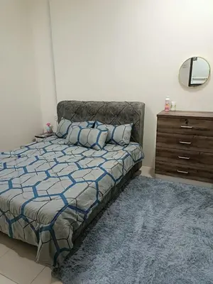 a bedroom with a bed and a dresser and a mirror at Amirah homestay in Kampong Sungai Wangi Dalam