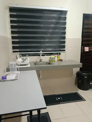 a kitchen counter with a sink and a window at Amirah homestay in Kampong Sungai Wangi Dalam