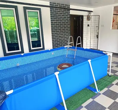 a swimming pool with blue tiled floor and windows at SR Kampar 2-Storey LANDED HOMESTAY in Kampar