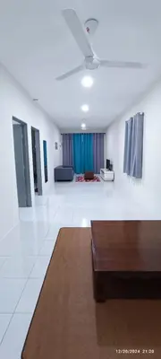 a living room with a couch and a table at Aflah Home in Tapah Road