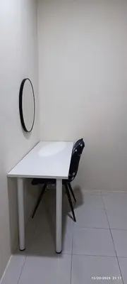 a white table with a mirror and a black chair at Aflah Home in Tapah Road