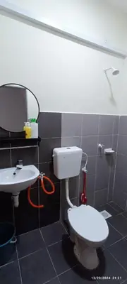 a bathroom with a toilet and a sink at Aflah Home in Tapah Road