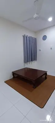 a bed in a room with two blue curtains at Aflah Home in Tapah Road