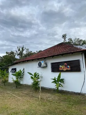 a white building with a sign on the side of it at Kerlingfornia Pond View Farm House in Kerling