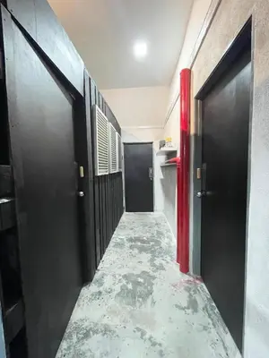 a hallway with black doors and a marble floor at Kerlingfornia Pond View Farm House in Kerling