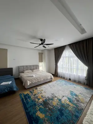 a bedroom with a bed and a ceiling fan at Mkm Villa cameron highland in Tanah Rata