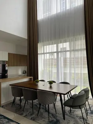 a dining room with a table and chairs in front of a window at Mkm Villa cameron highland in Tanah Rata