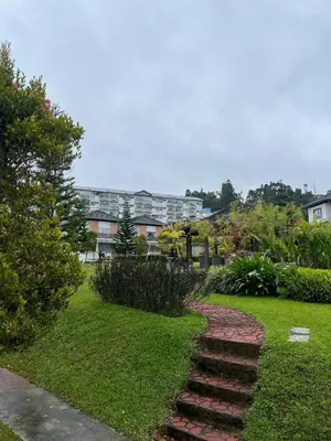 a set of stairs in a park with buildings in the background at Mkm Villa cameron highland in Tanah Rata