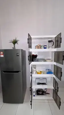 a kitchen with a black refrigerator in a room at Comfy21 Homestay Ipoh near Sunway Tambun in Ipoh