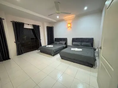 a living room with two beds and a couch at Comfy21 Homestay Ipoh in Ipoh