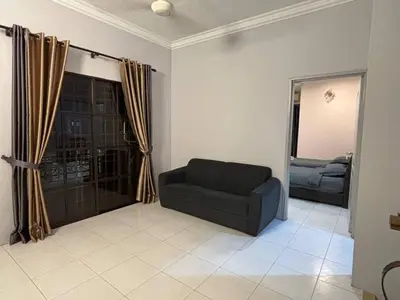 a living room with a couch and a window at Comfy21 Homestay Ipoh in Ipoh