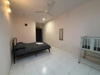 a bedroom with a bed in the corner of a room at Comfy21 Homestay Ipoh in Ipoh