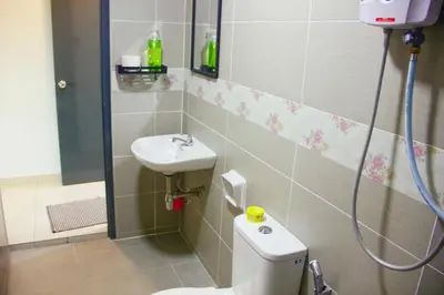 a bathroom with a toilet and a sink at Classic Spot - Meru Raya in Ipoh