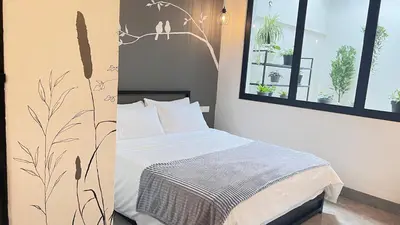 a bedroom with a bed and two windows at Single Terrace at Canning Ipoh Newly Renovated in Ipoh