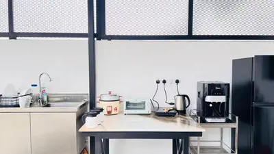 a kitchen with a counter top with a refrigerator at Single Terrace at Canning Ipoh Newly Renovated in Ipoh