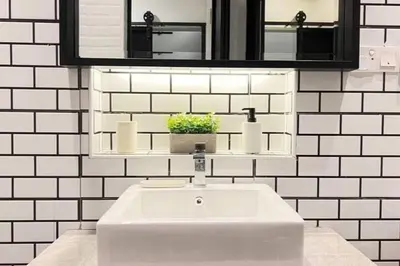 a white bathroom with a sink and a mirror at Single Terrace at Canning Ipoh Newly Renovated in Ipoh