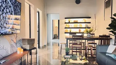 a living room with a couch and a table and chairs at Single Terrace at Canning Ipoh Newly Renovated in Ipoh
