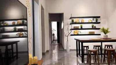 a dining room with a table and some stools at Single Terrace at Canning Ipoh Newly Renovated in Ipoh