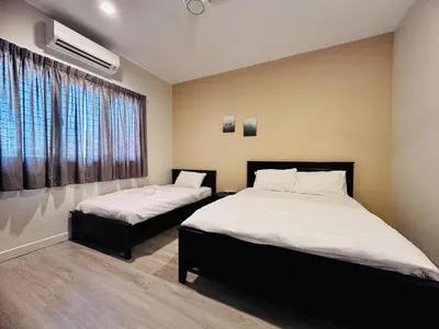 a bedroom with two beds and a window at New Island Luxe Retreat Vacation Home 14pax Nearby Gurney in Tanjung Bungah